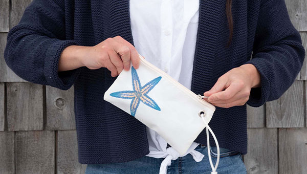 Woman holding starfish wristlet